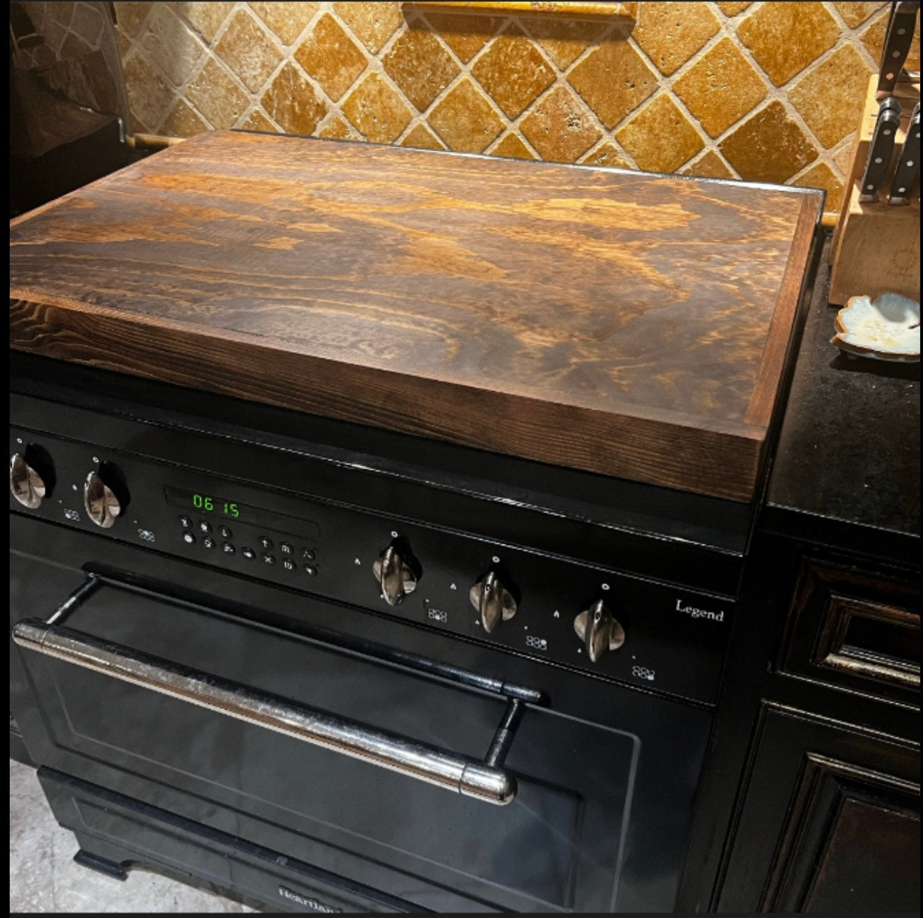 Handmade pine stove cover, box style, on a kitchen stovetop