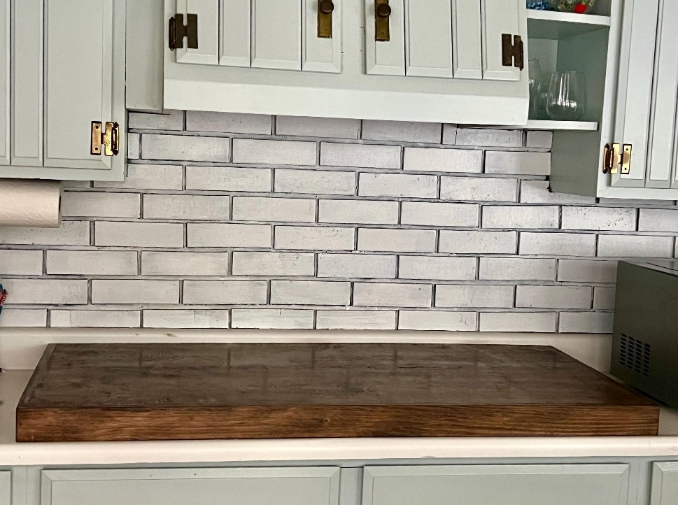 Handmade pine stove cover, box style, on a kitchen stovetop