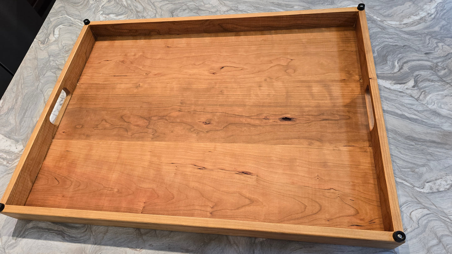 Handmade Cherry hardwood stove cover and cutting board on a kitchen stovetop. This shows the underside of the cover. 
