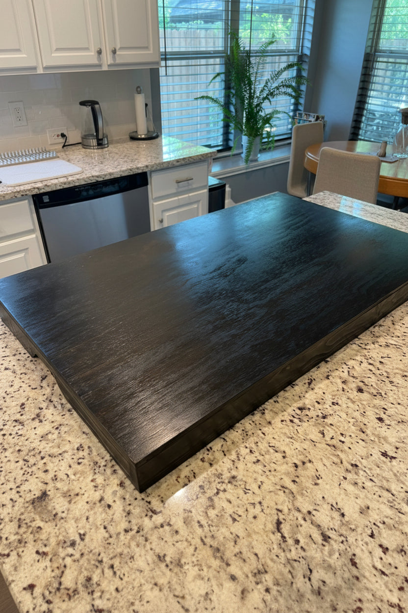 Handmade pine stove cover, box style, on a kitchen stovetop