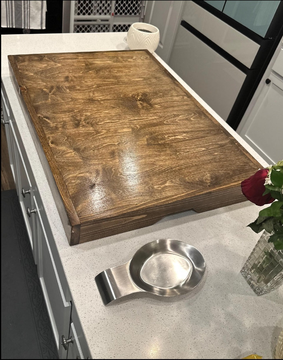 Handmade pine stove cover, box style, on a kitchen stovetop