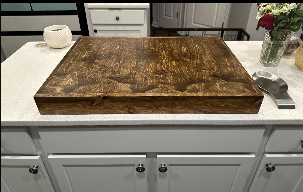 Handmade pine stove cover, box style, on a kitchen stovetop